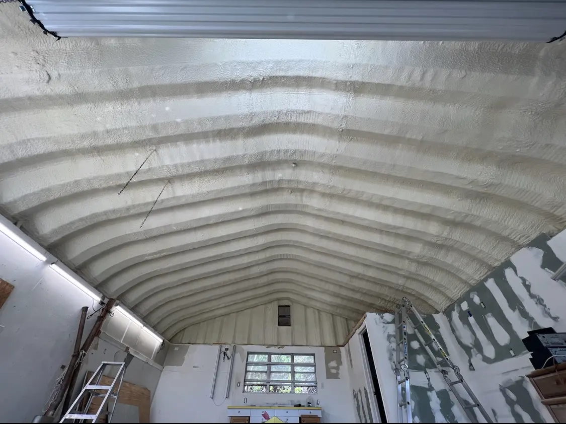 Spray polyurethane foam applied to the underside of a metal roof deck in Clearfield